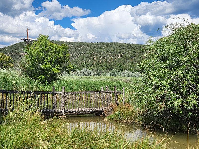 grounds-at-pecos-monastery Pecos River in the summer season